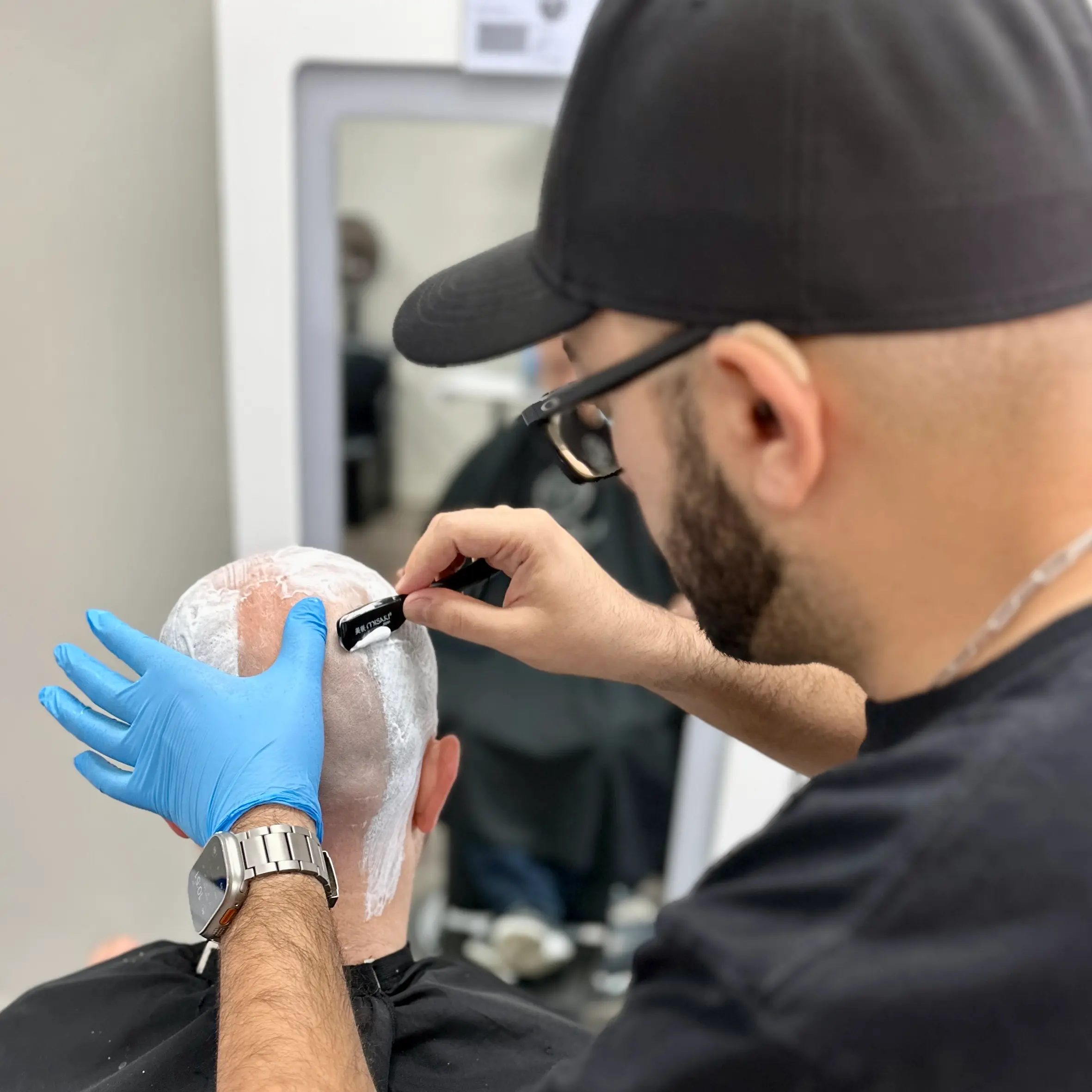 Reza Barber providing professional head shave in Irvine, CA.