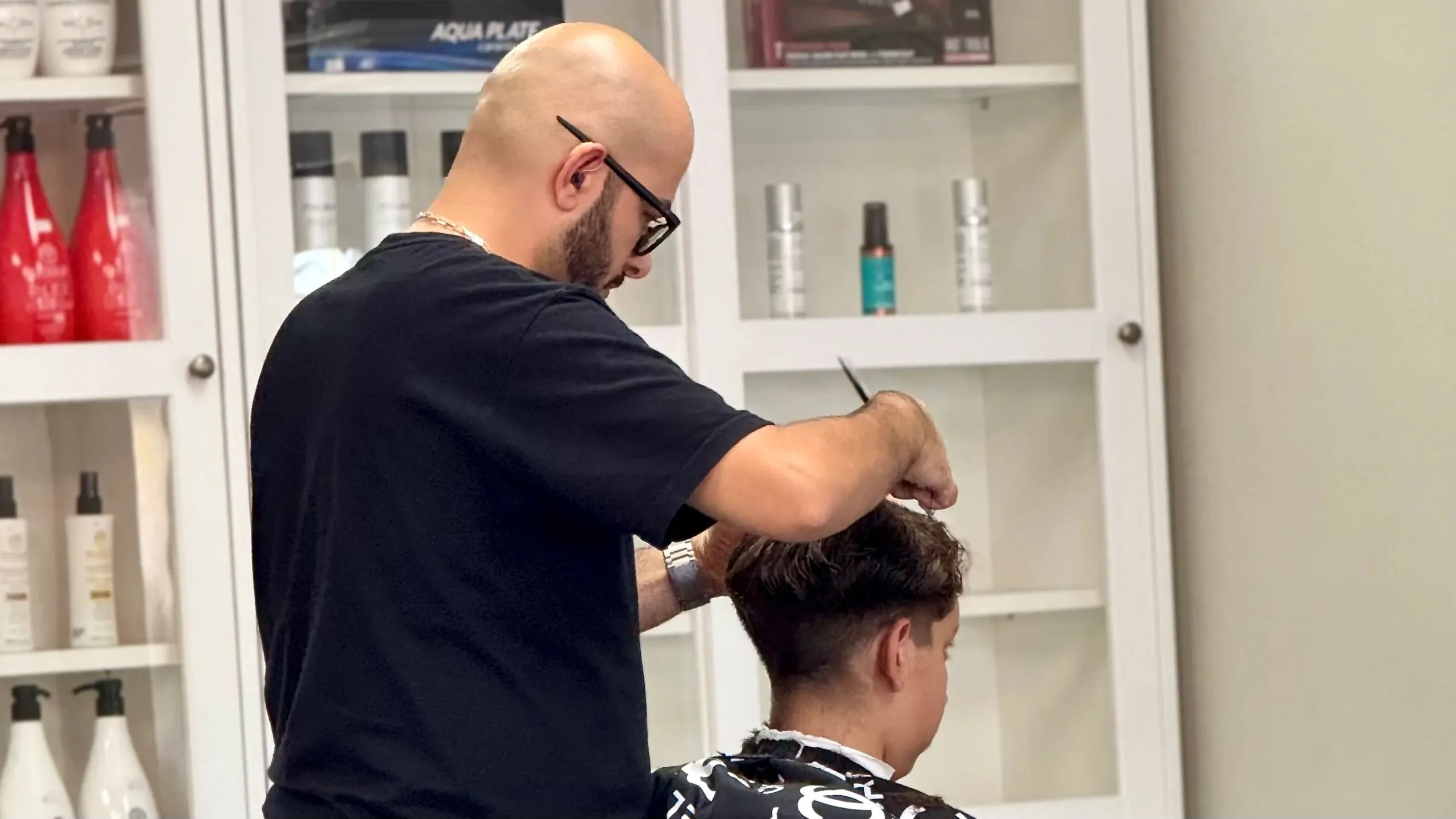 Reza Barber giving a men’s haircut in Irvine, CA at Kija Hair Salon
