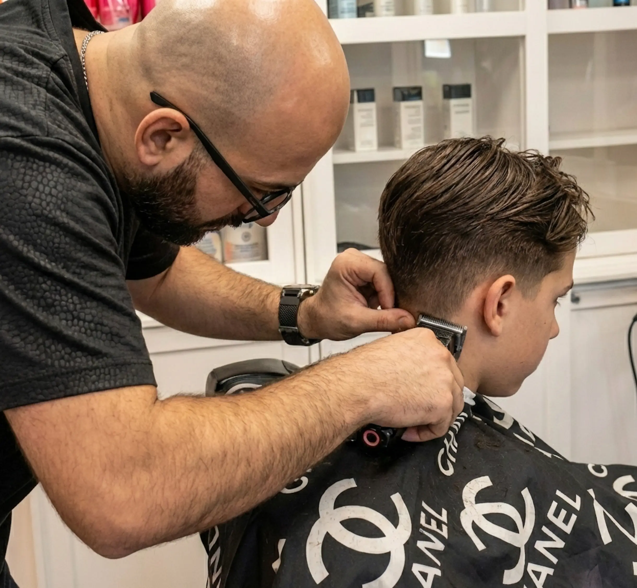 Reza Barber giving a precision scissor cut inside Kija Hair Salon, Irvine CA