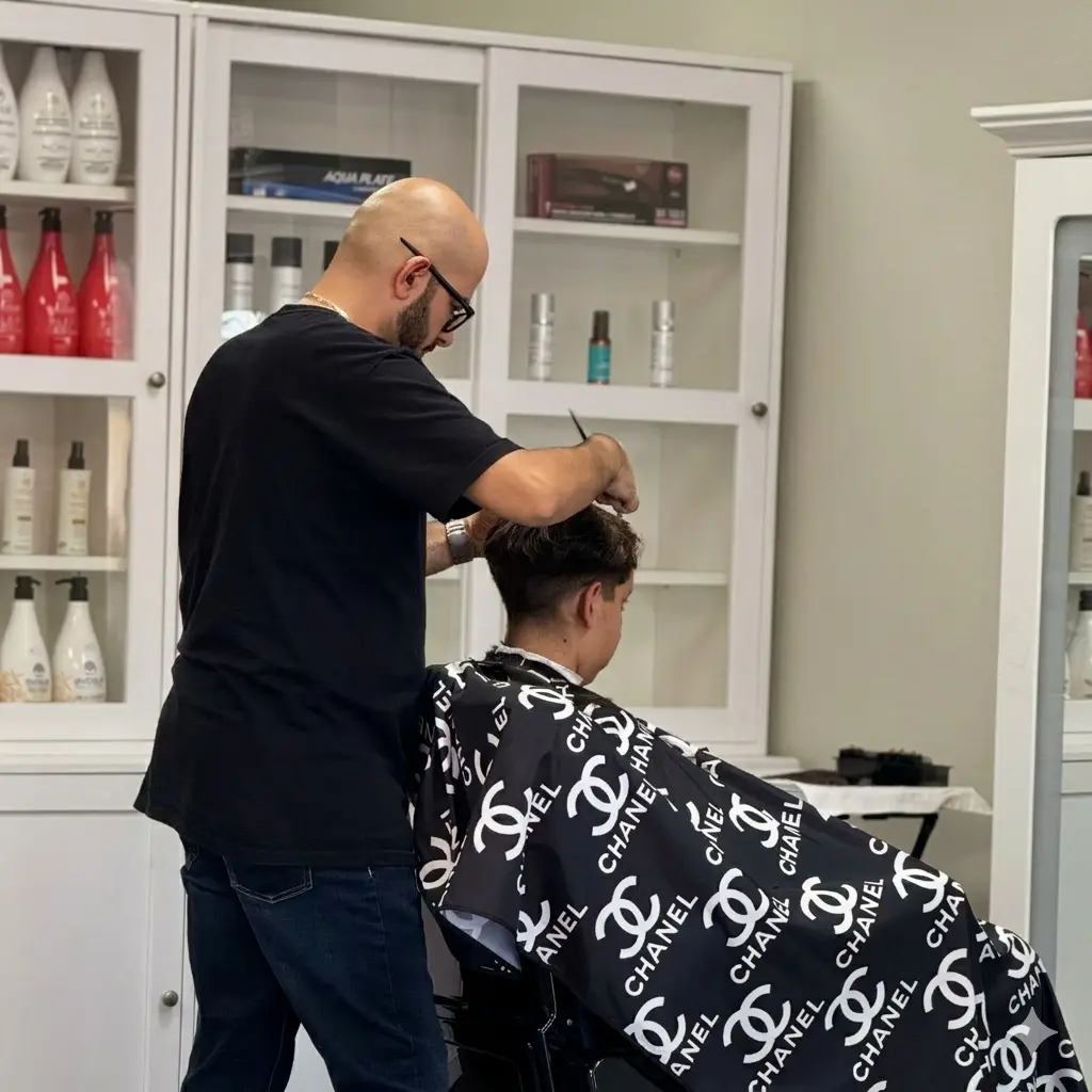 Reza Barber giving a precision scissor cut inside Kija Hair Salon, Irvine CA