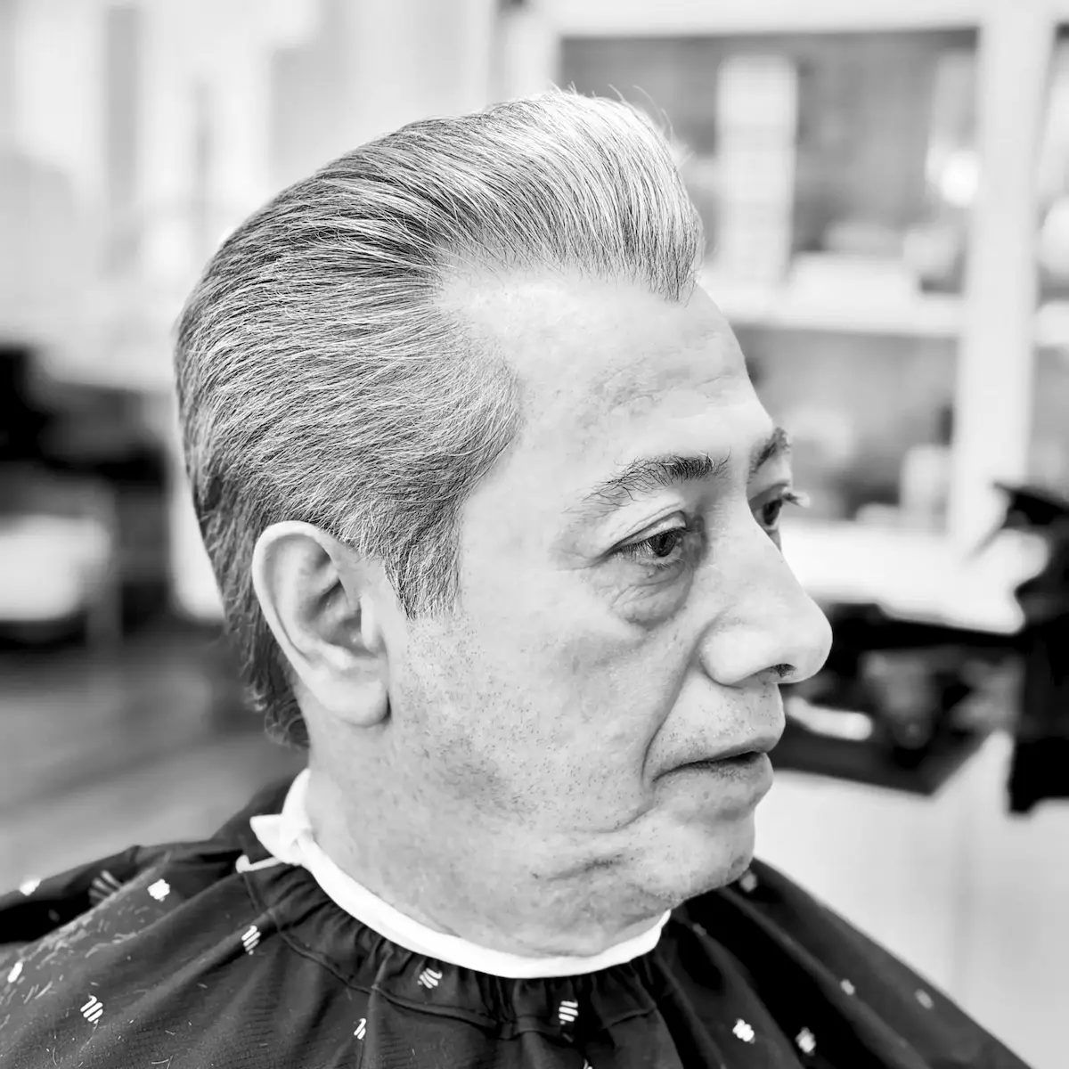 Men's haircut with a natural taper by Reza Barber in Irvine, CA — black and white